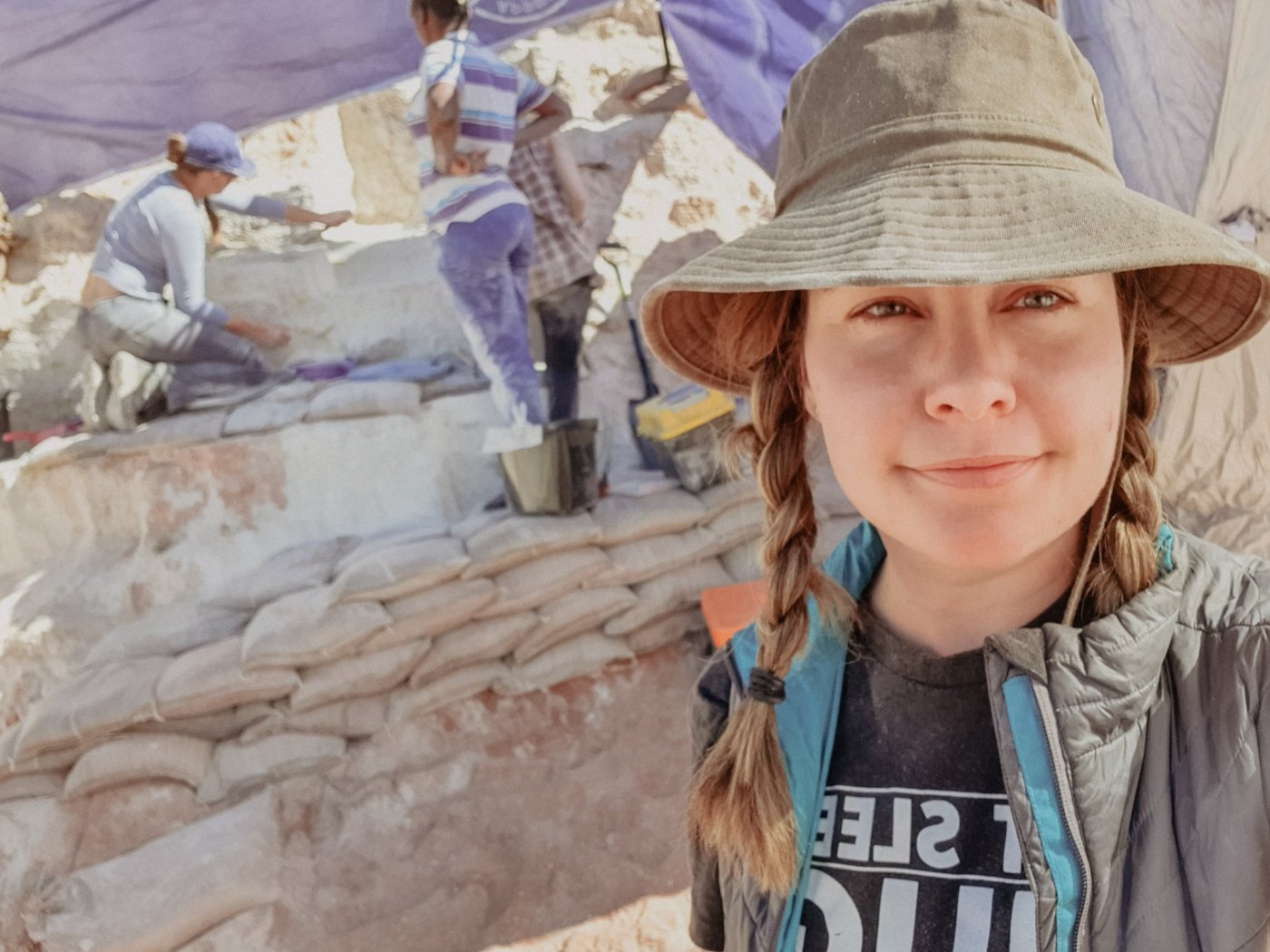 On site, the excavation team working behind her